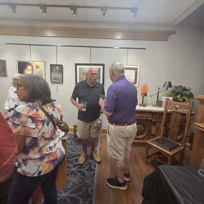 Pete Spratlin chatting with a visitor to his artist reception.