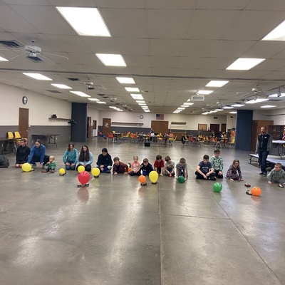 4-H members race balloon cars as part of a 4-H project meeting.