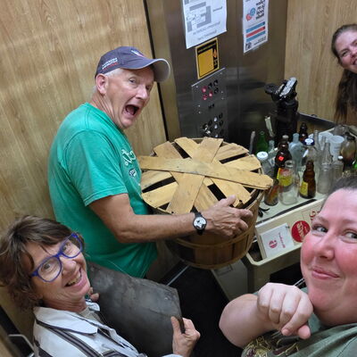 staff and volunteers taking the elevator to the attic where 1/3 of the museum collection is stored